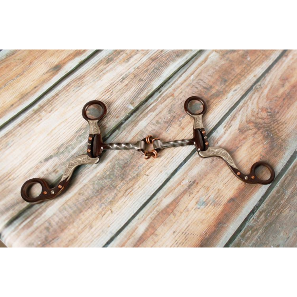Showman ® brown steel bit with engraved copper studs and silver accents on the cheeks. - Double T Saddles